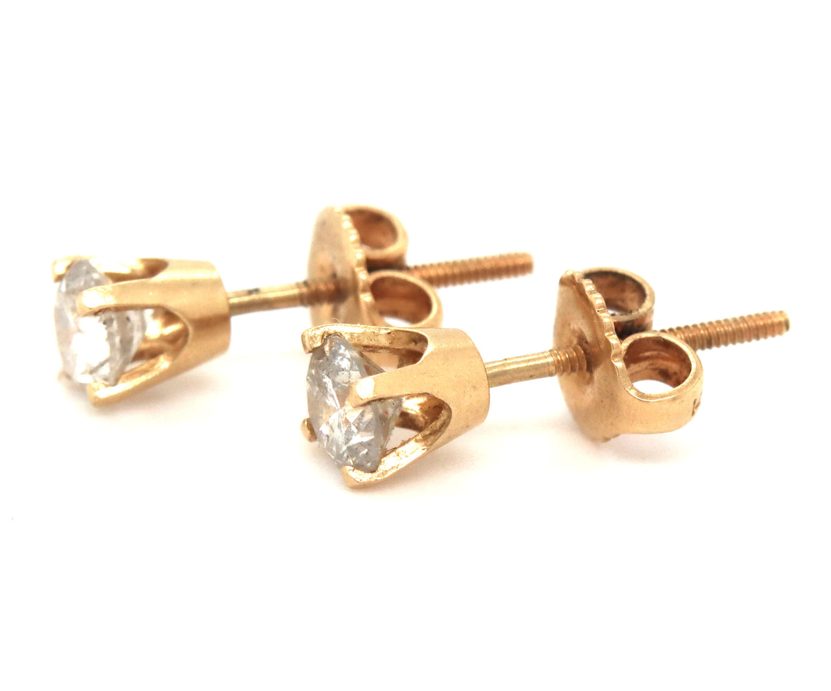 One pair of 14kt yellow gold round brilliant cut diamond stud earrings