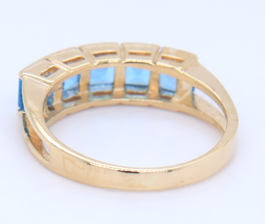 14kt Yellow gold channel set princess cut blue topaz five stone band