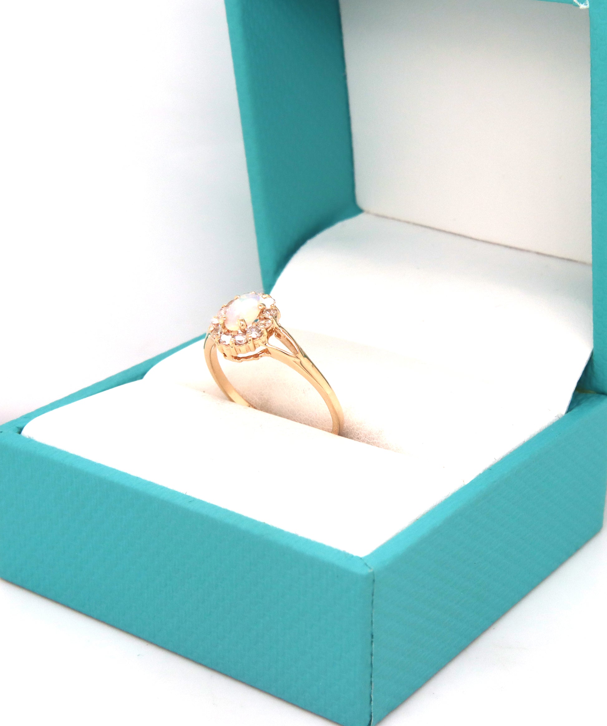 14kt Yellow gold oval opal and diamond halo ring