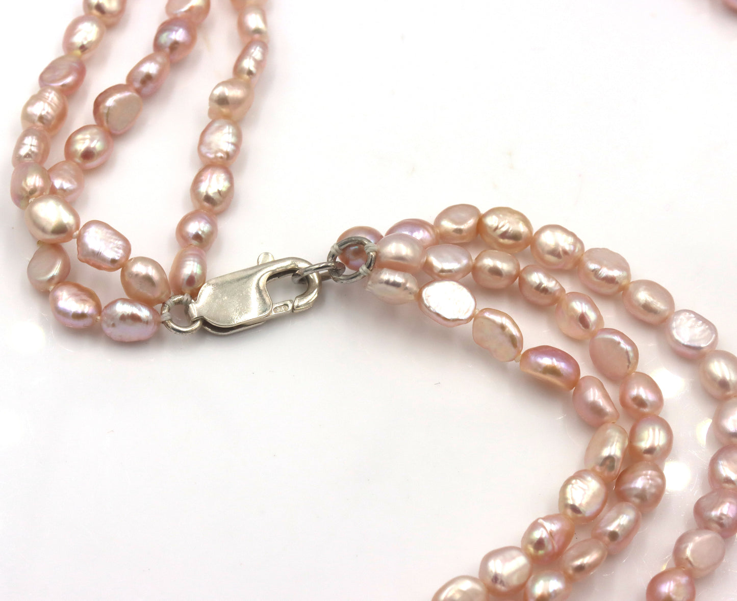Pearl square pendant on multi strand pearl necklace