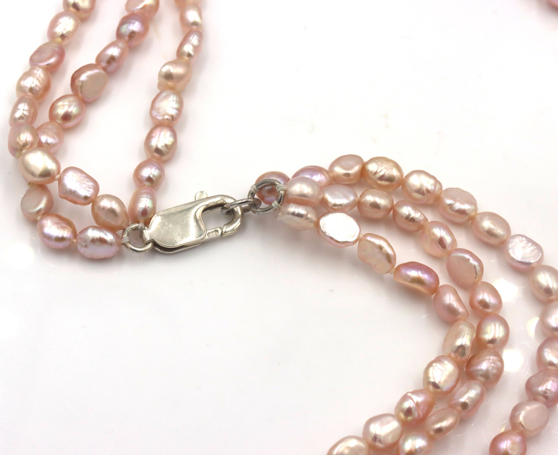 Pearl square pendant on multi strand pearl necklace