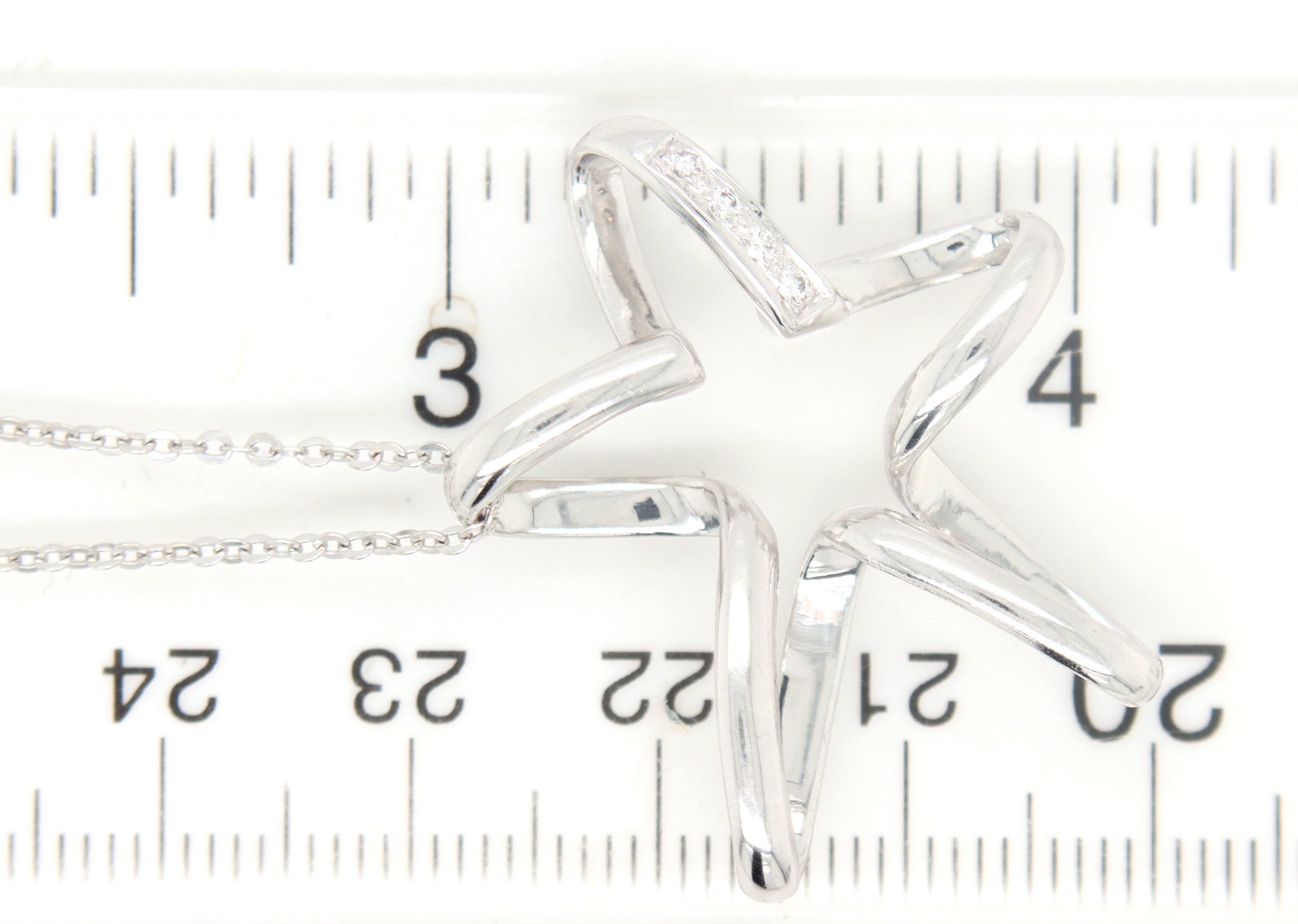 18kt White gold diamond accent free form star pendant on chain