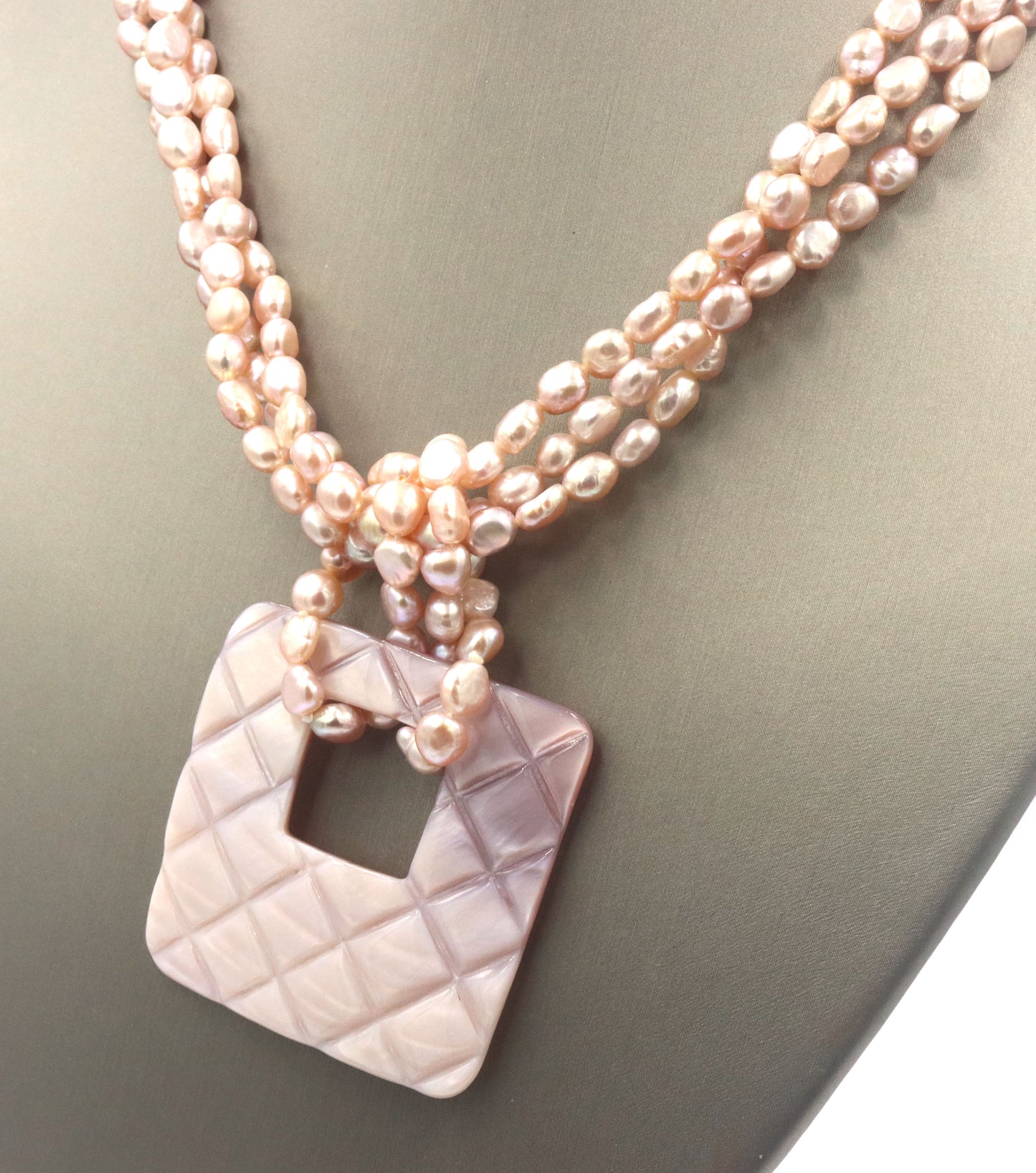 Pearl square pendant on multi strand pearl necklace
