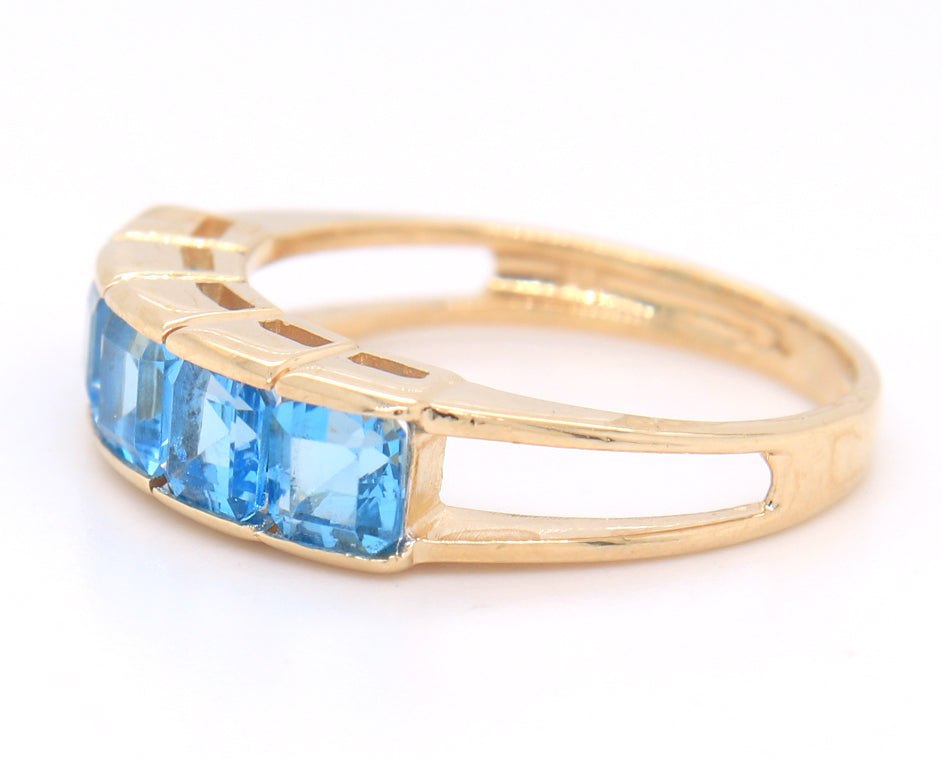 14kt Yellow gold channel set princess cut blue topaz five stone band