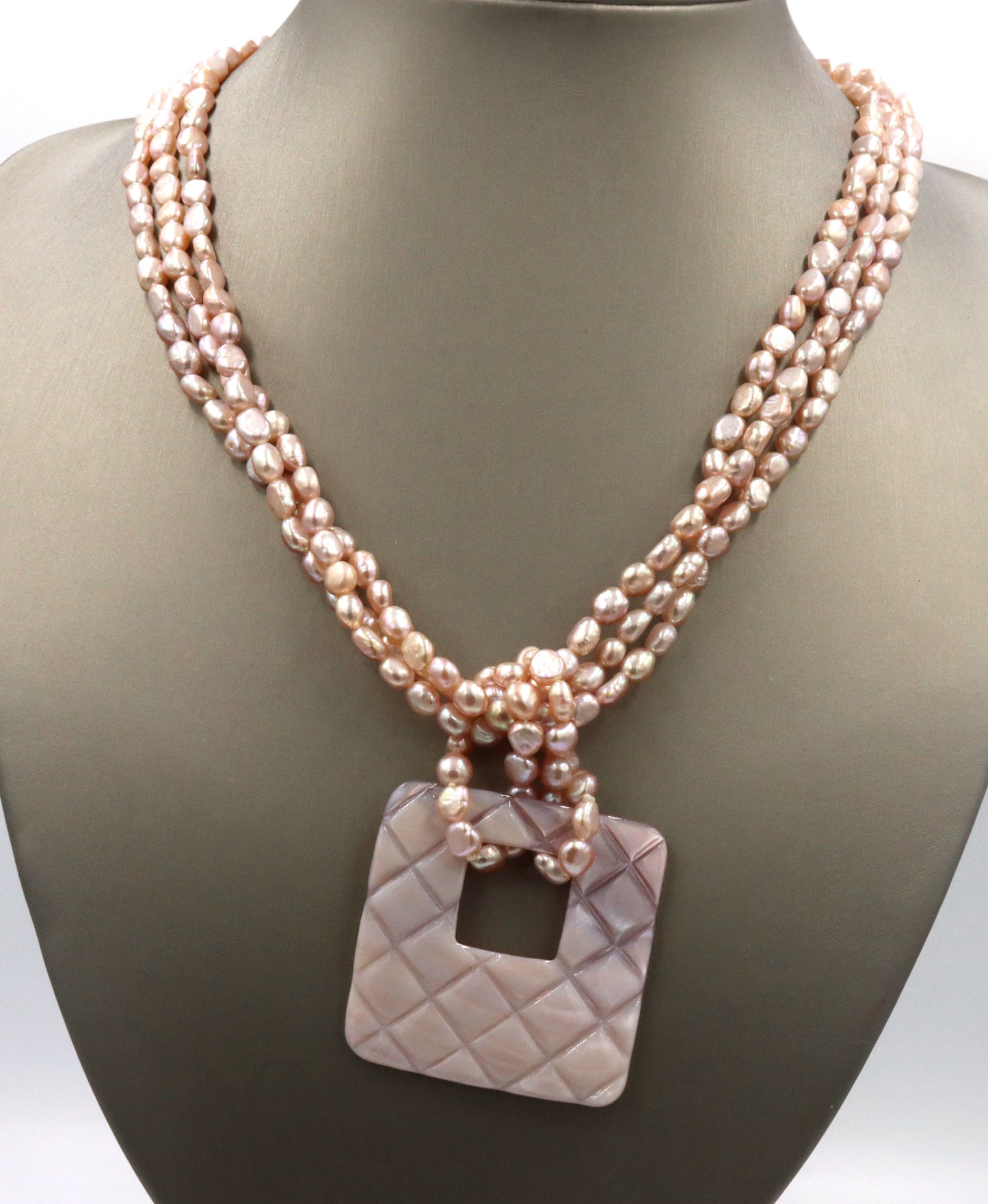 Pearl square pendant on multi strand pearl necklace
