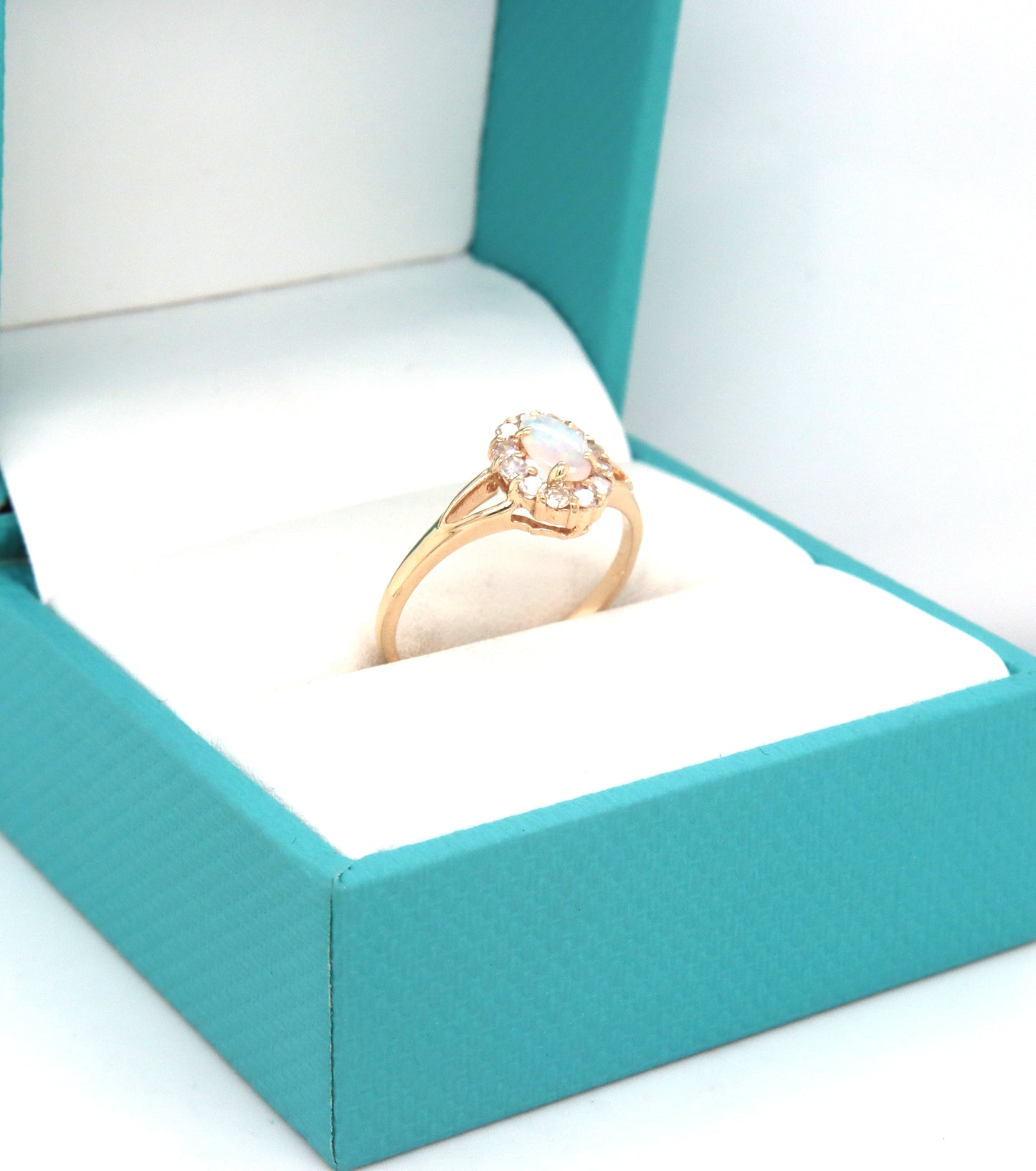 14kt Yellow gold oval opal and diamond halo ring