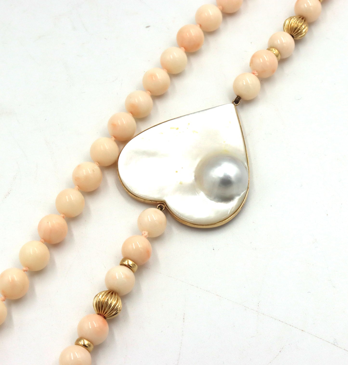 Pink quartz beaded necklace with mother of pearl heat shaped pendant