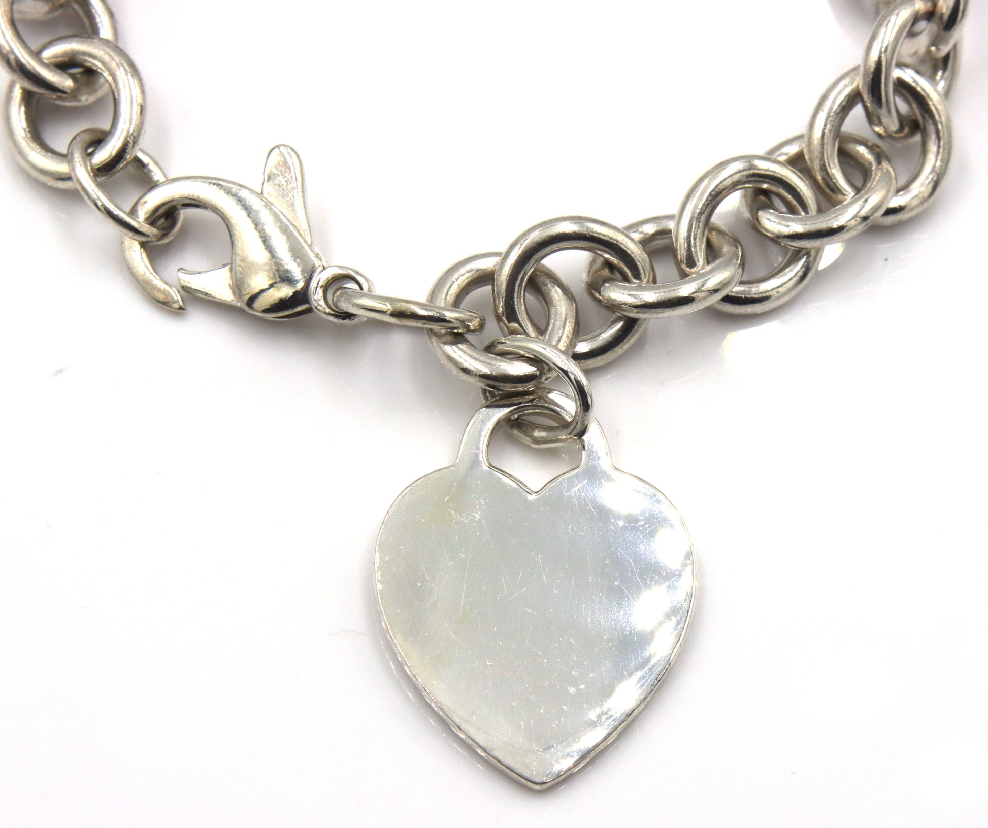 Tiffany & Co link bracelet with heart shaped charm