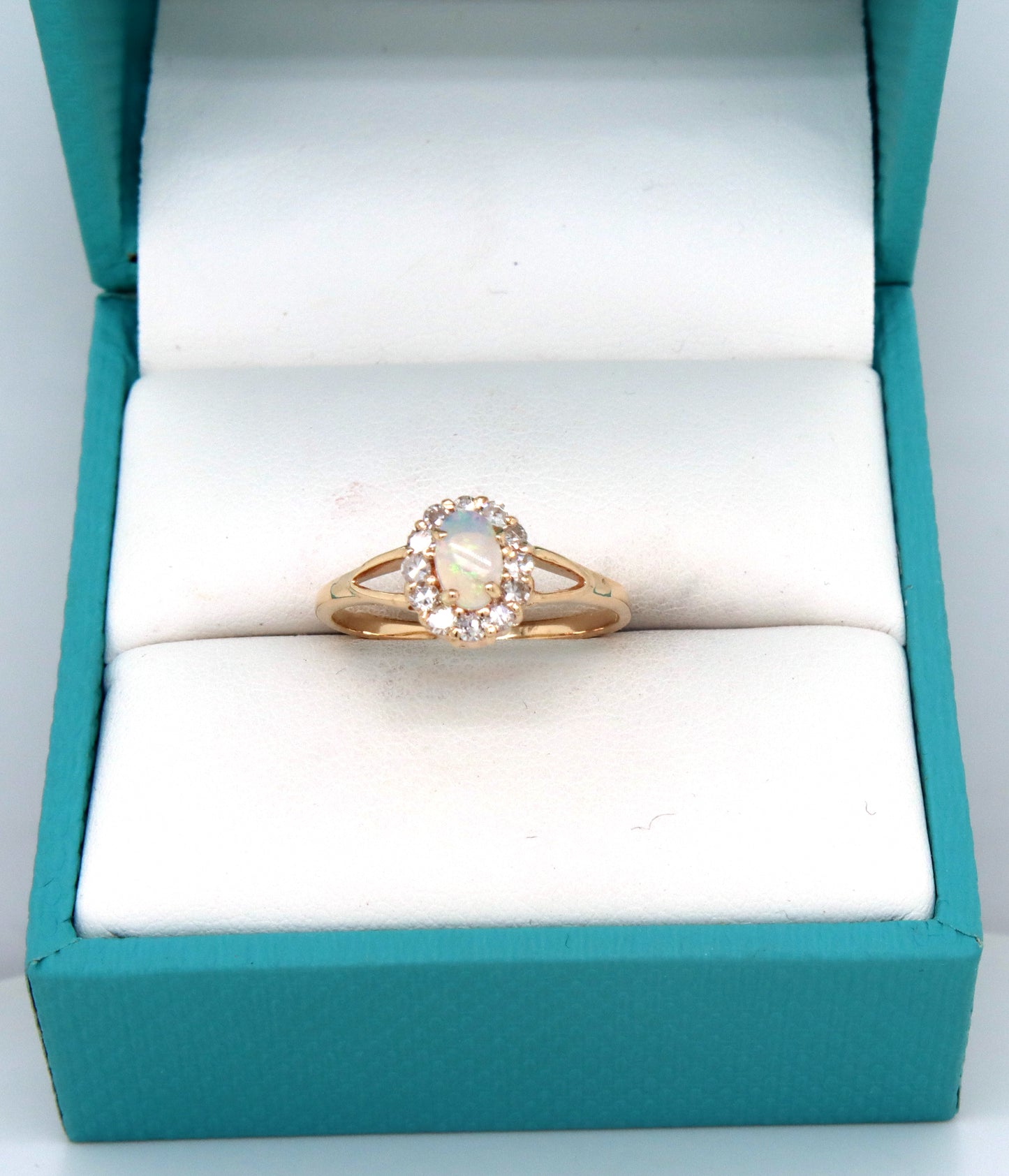 14kt Yellow gold oval opal and diamond halo ring