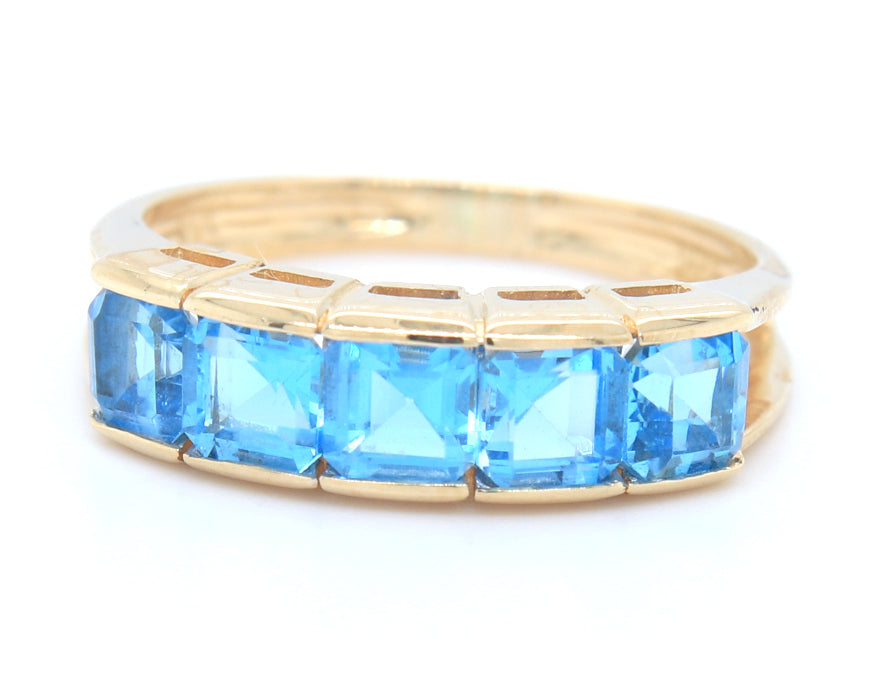 14kt Yellow gold channel set princess cut blue topaz five stone band