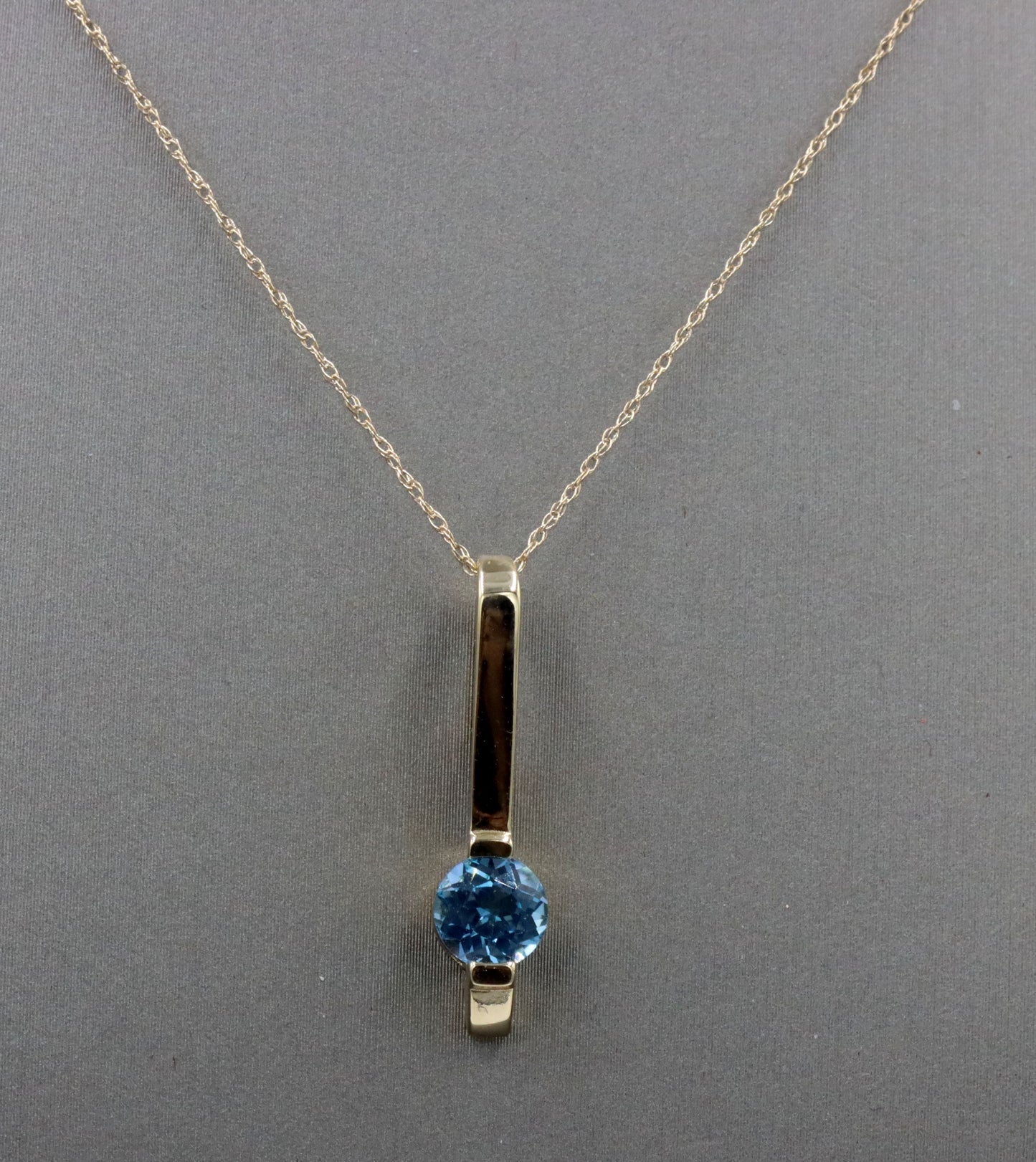14kt Yellow gold blue topaz bar pendant on chain