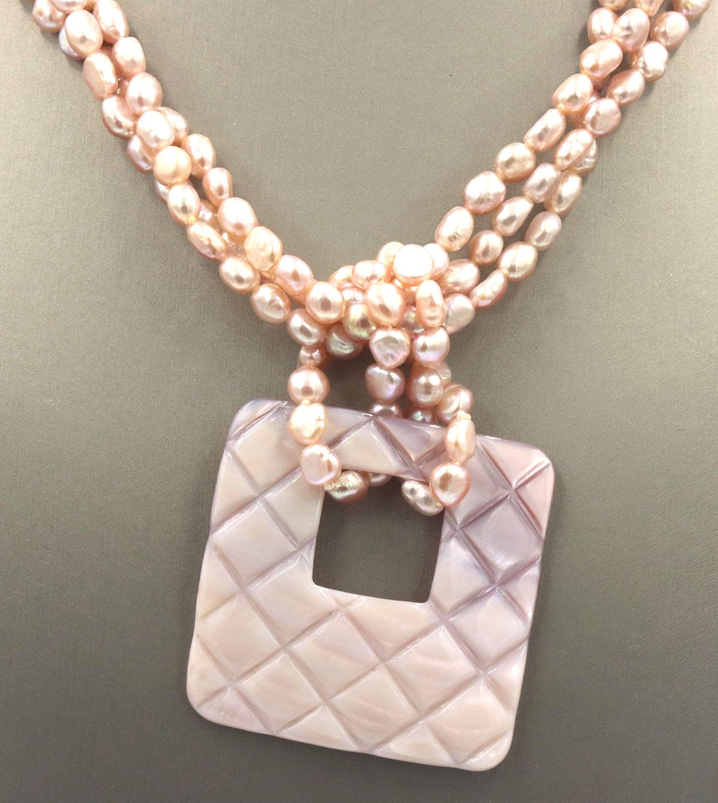 Pearl square pendant on multi strand pearl necklace