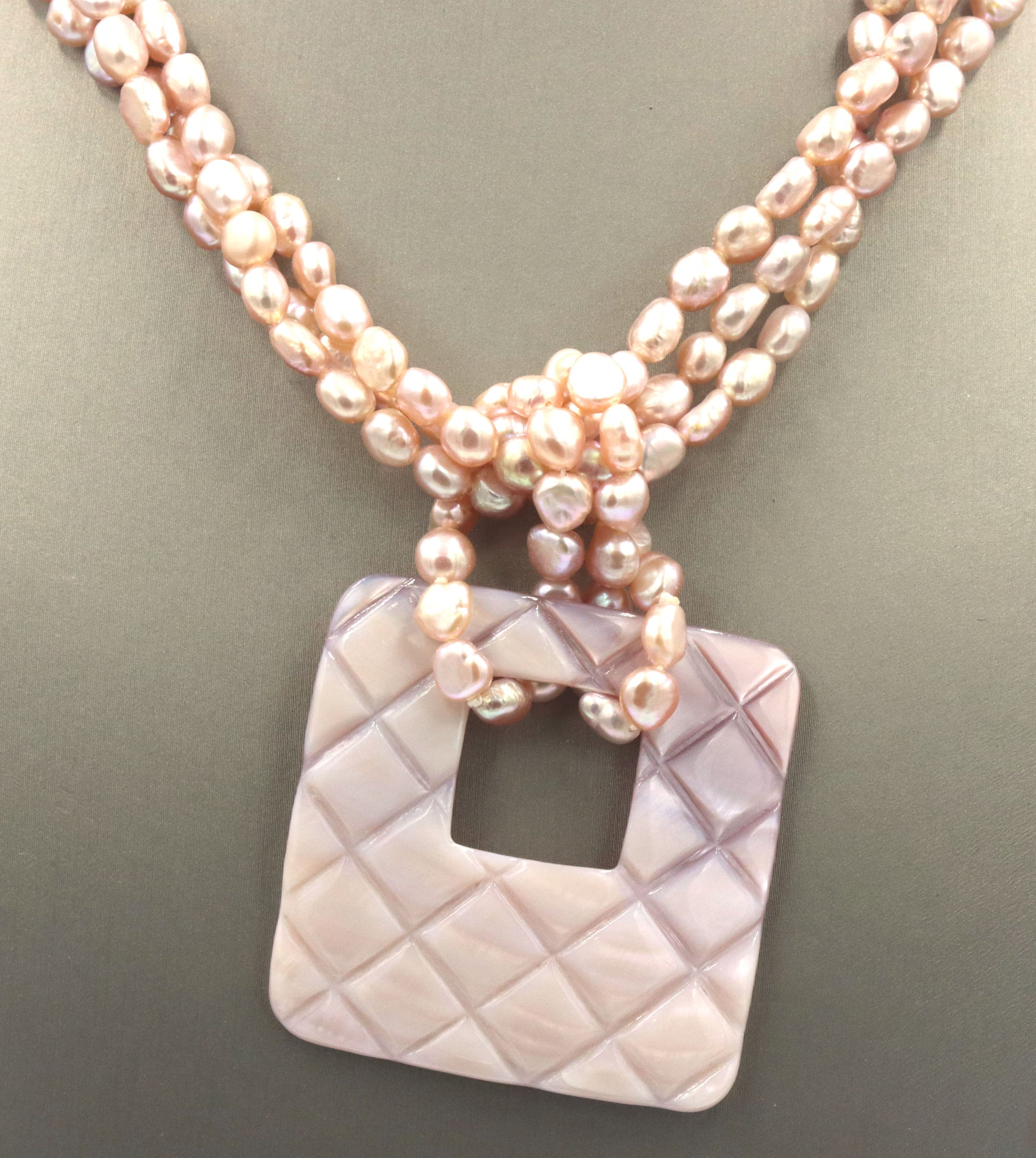 Pearl square pendant on multi strand pearl necklace